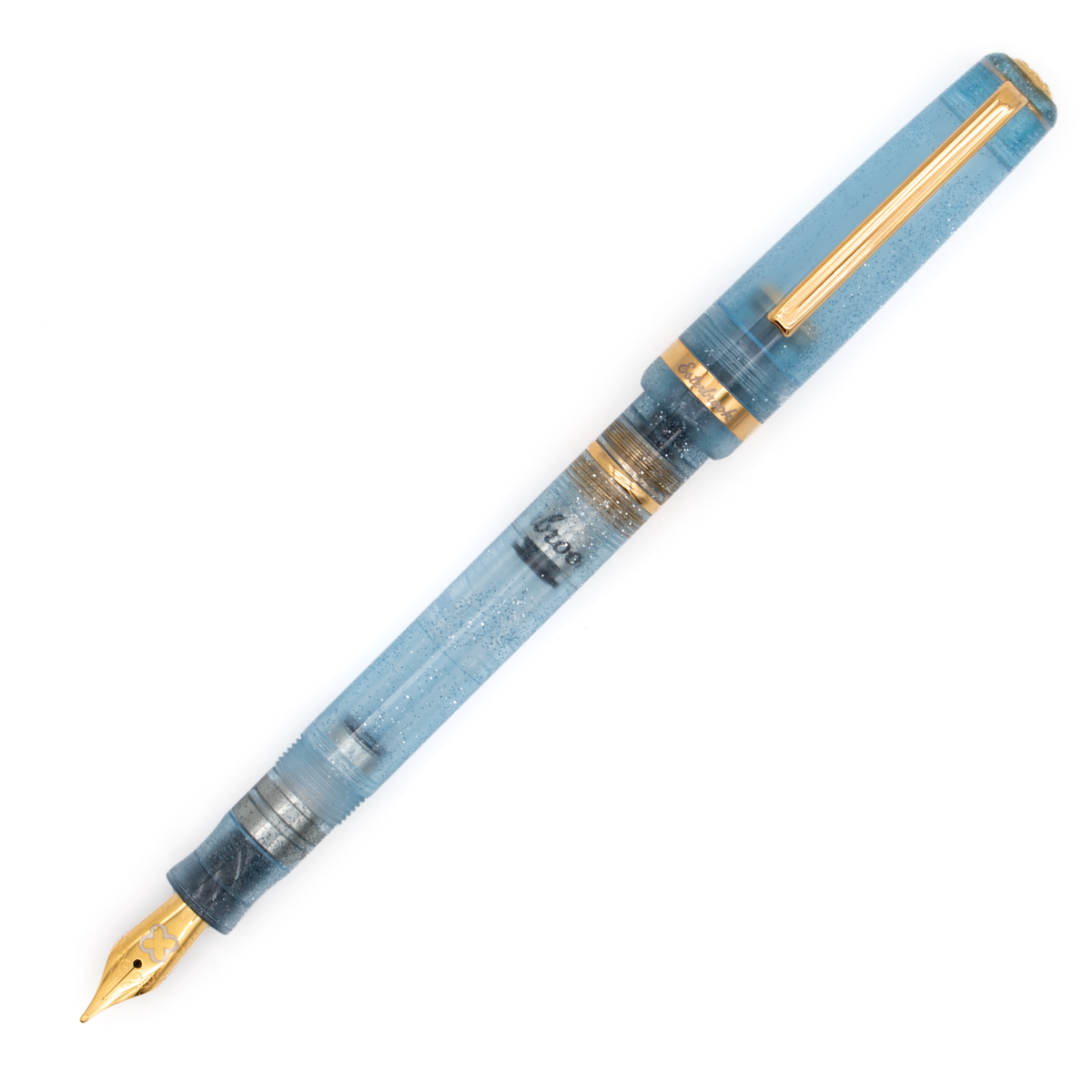 A light blue transparent fountain pen with silver glitter accents along the barrel, gold trim, a gold nib. The cap posted on the pen and is shown diagonally on a plain white background.