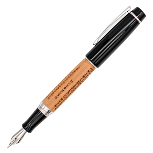 A wood barrel fountain pen with the Sanskrit 'Heart Sutra' engraved in it with black and silver trim details, shown with its cap posted on the end of the barrel on a plain white background.