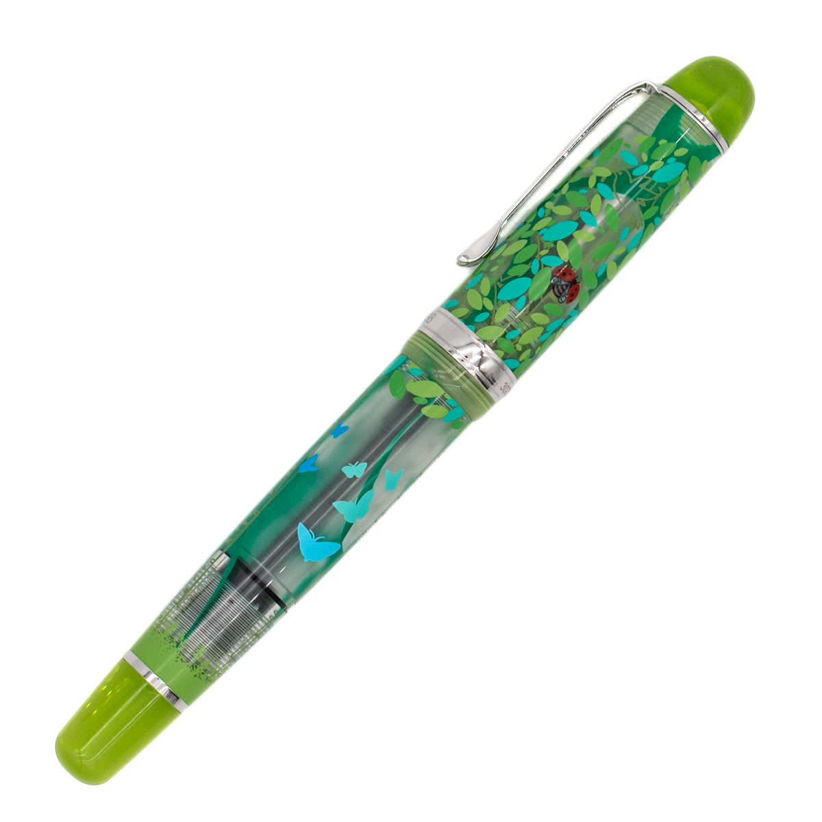 A clear frosted fountain pen with translucent lime green details and silver trim with details of turquoise and green leaves and butterflies, and a red ladybug on the cap, diagonally on a white background.
