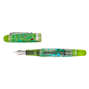 A clear frosted fountain pen with translucent lime green details and silver trim with details of turquoise and green leaves and butterflies, and a red ladybug on the cap. The capis parallel to the barrel and the pen is on a white background.