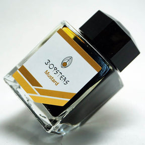 3 Oysters Mustard from the Delicious collection is a medium brown-yellow fountain pen ink with medium shading. It dries in 30 seconds in a medium nib on Rhodia and has a dry flow. The glass bottle has a cut out corner to lean the bottle for a decorative display. 3 Oysters ink is made in Korea.  Pantone color: 1245C